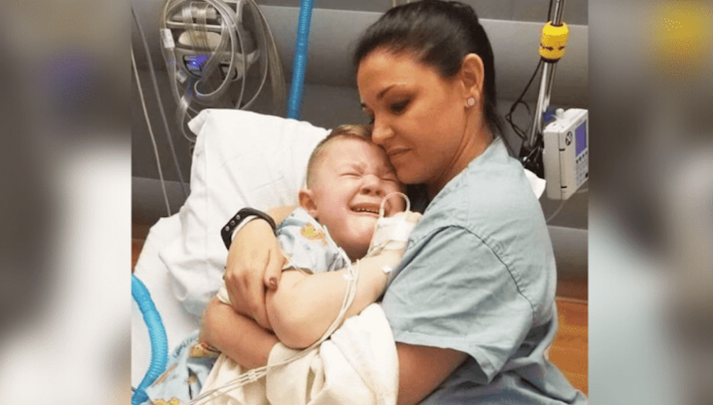 Mom enters son’s hospital room to comfort 5-year-old son after surgery, sees a kind nurse snuggling him