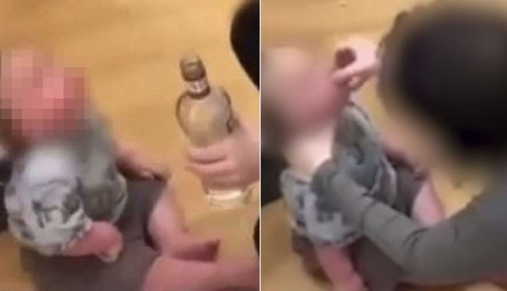Mother was caught on video pouring alcohol into a cap and tilting her baby’s head back before pouring it into their mouth while the baby’s dad is seen in the background oblivious to what is going on